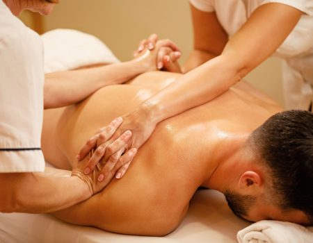 unrecognizable-massage-therapists-massaging-together-man-s-back-health-spa
